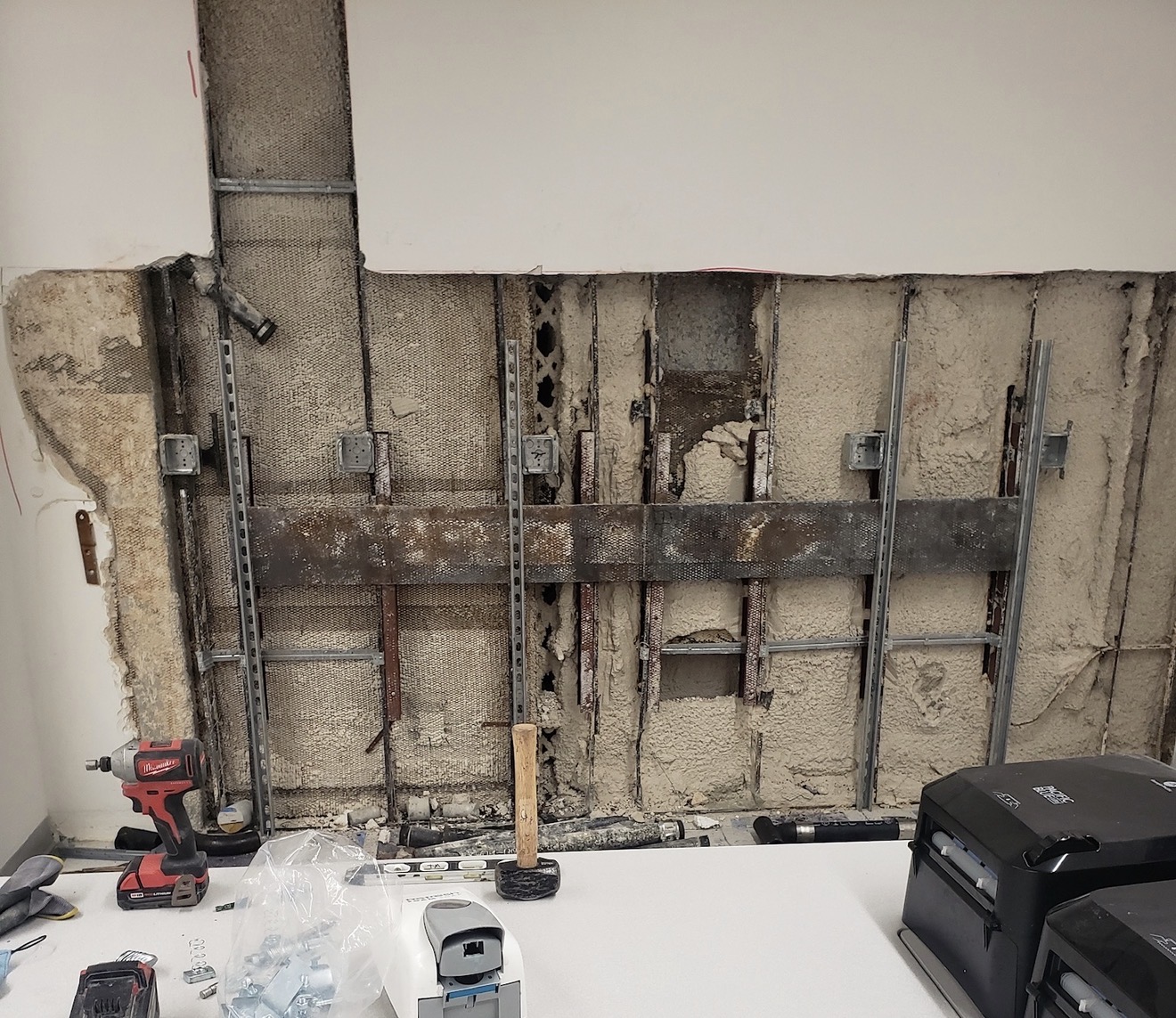 Commercial wall opened before rough plumbing work