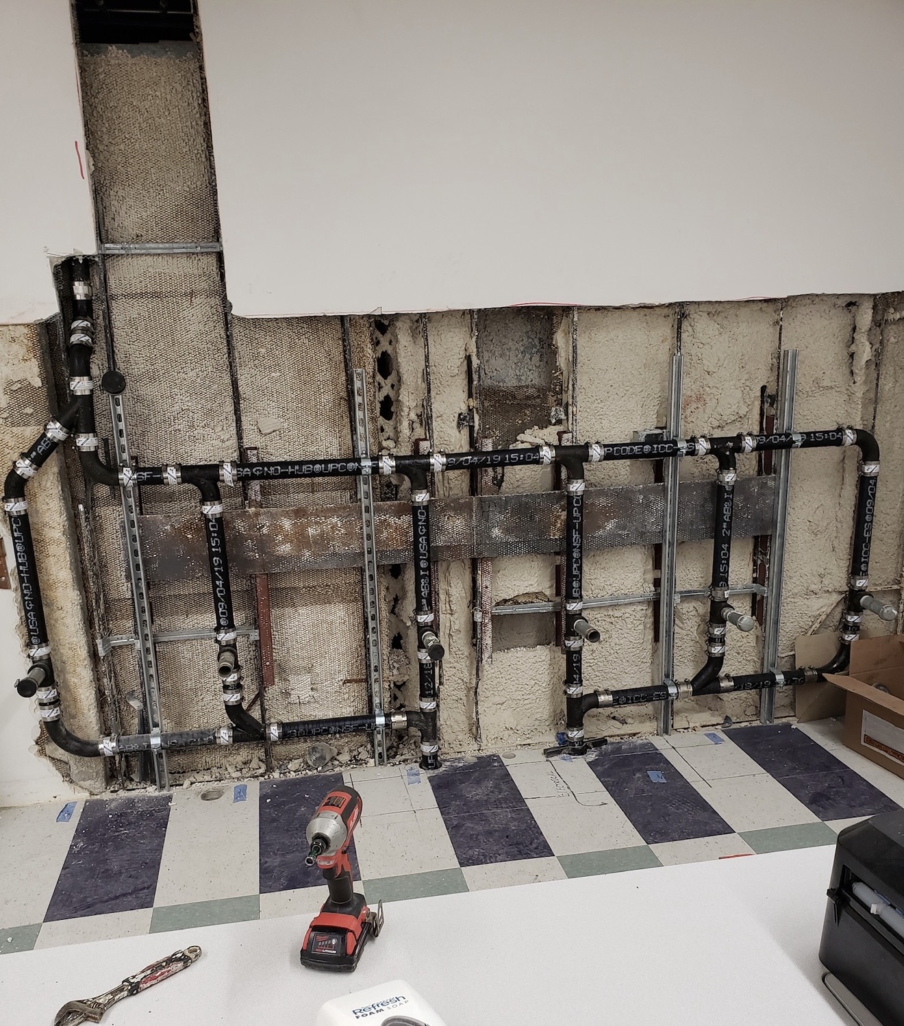 Commercial rough plumbing stage with drainage lines installed