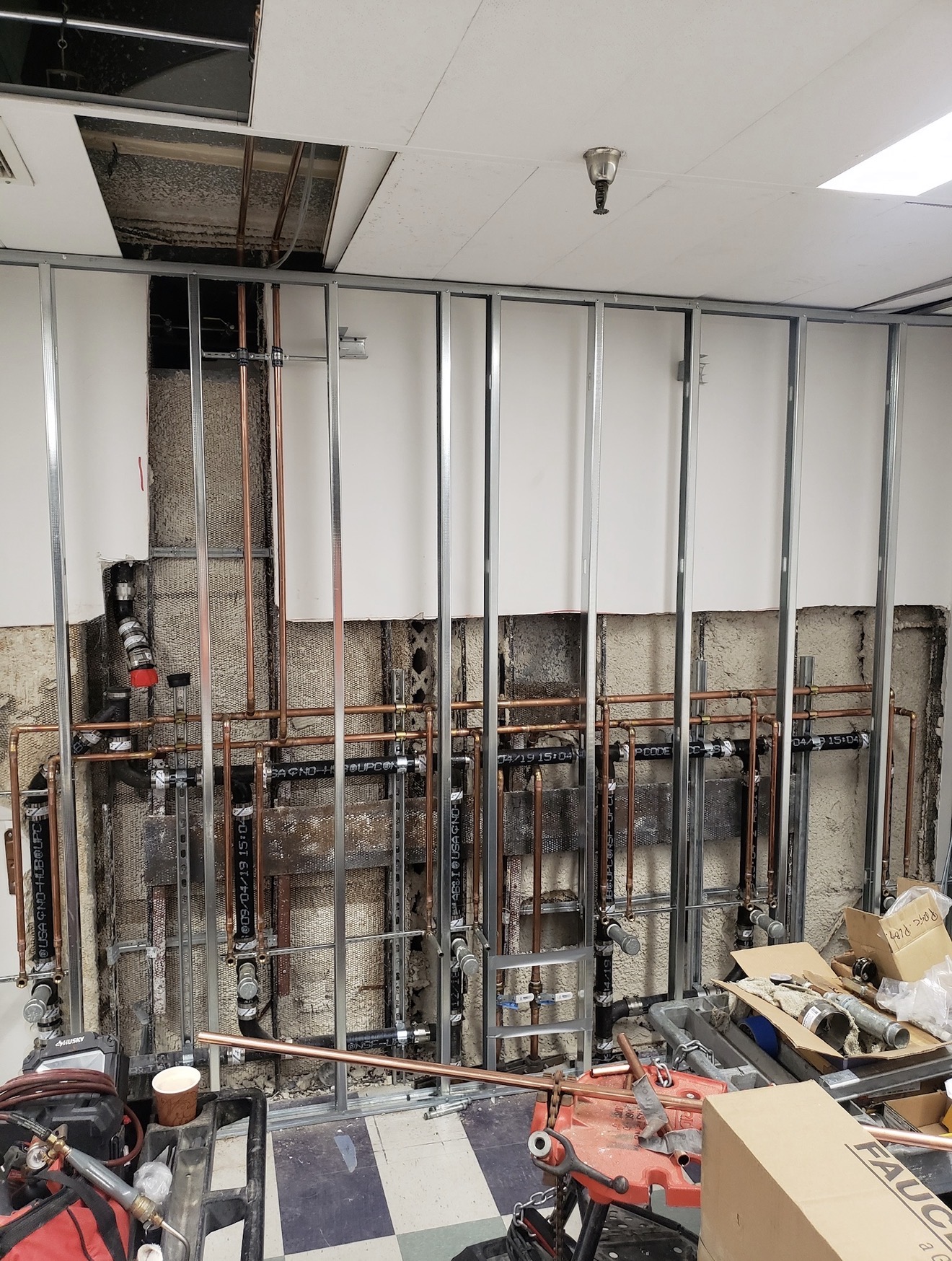 Commercial plumbing progress with metal studs and copper supply lines